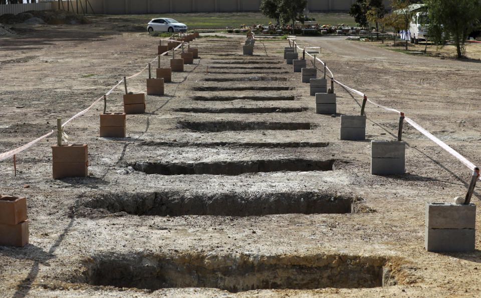 Empty graves are seen at the Durbanville Memorial Park in Cape Town, South Africa, Thursday, May 21, 2020. With dramatically increased community transmissions, Cape Town has become the centre of the coronavirus outbreak in South Africa and the entire continent. (AP Photo/Nardus Engelbrecht)