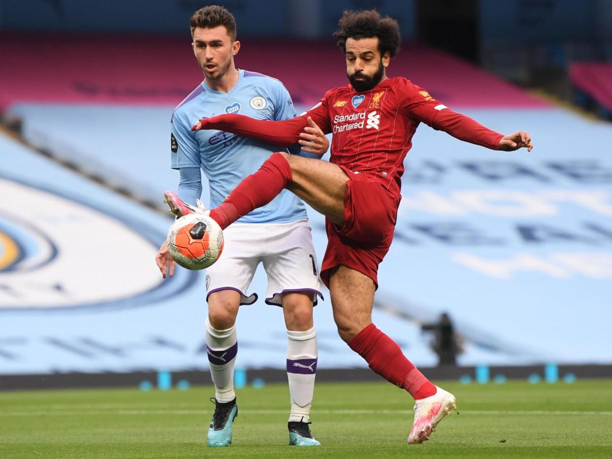 Manchester City's French defender Aymeric Laporte (L) vies with Liverpool's Egyptian midfielder Mohamed Salah: POOL/AFP via Getty Images