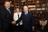 FILE - Greek President Karolos Papoulias, right, shakes hands with with Turkish Prime Minister Tayyip Erdogan during their meeting in Athens, Friday, May 14, 2010. Papoulias, a former President of Greece, has died at the age of 92, Greece's state news agency ANA reported on Sunday, Dec. 26, 2021. Papoulias, a lawyer by training, was close to socialist leader Andreas Papandreou and served in all his governments from 1981-1996, all in foreign affairs positions, ending as Foreign Minister. (John Kolesidis, Pool Photo via AP, File)