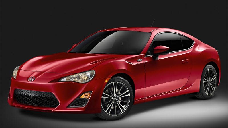 A photo of a red Scion FRS sports car in a studio. 