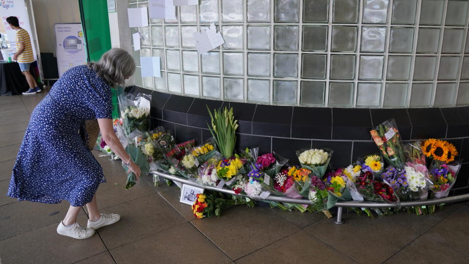A lady leaves flowers outside Perivale Tesco, Greenford, where 87-year-old Thomas O'Halloran, who was fatally stabbed in Greenford, west London on Tuesday, used to play his accordion. Picture date: Friday August 19, 2022.