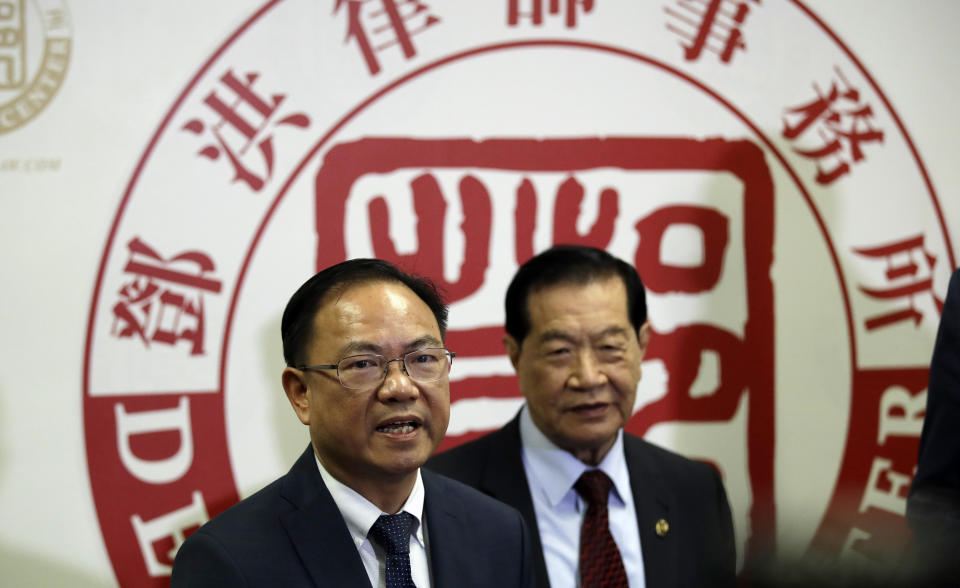 From left, attorney Daniel Deng and forensic scientist Henry Lee hold a joint news conference regarding the fatal police shooting of Chinese immigrant Li Xi Wang Wednesday, Aug. 28, 2019, in Rosemead, Calif. Lawyers are pursuing claims against the city of Chino, Calif., for the fatal shooting of an unarmed man by a police officer who was part of team serving a search warrant on a suspected illegal marijuana operation. (AP Photo/Marcio Jose Sanchez)