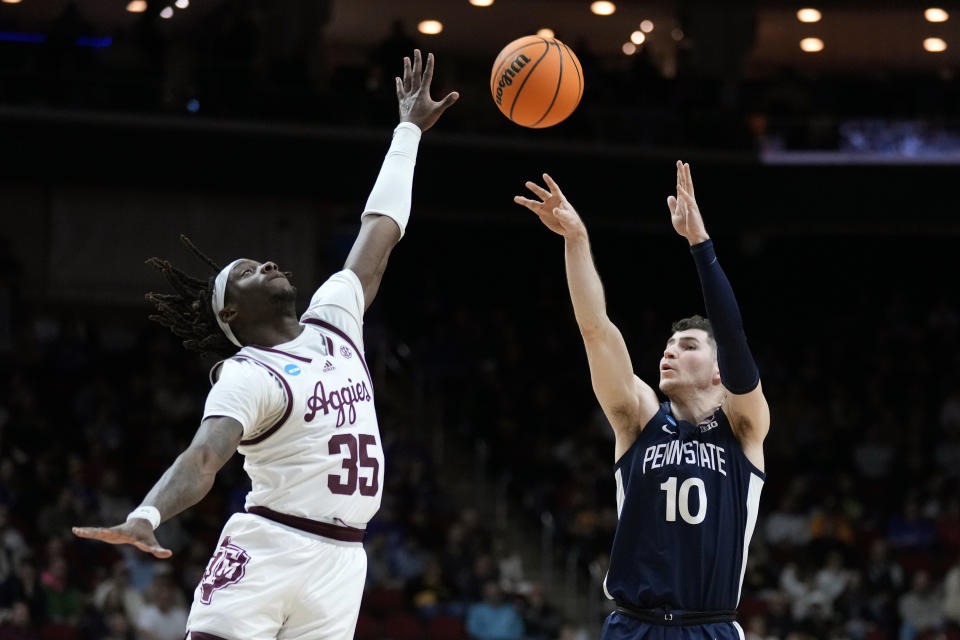 Penn State guard Andrew Funk (10) shoots a 3-point basket over Texas A&M guard Manny Obaseki (35) in the second half of a first-round college basketball game in the NCAA Tournament, Thursday, March 16, 2023, in Des Moines, Iowa. (AP Photo/Charlie Neibergall)