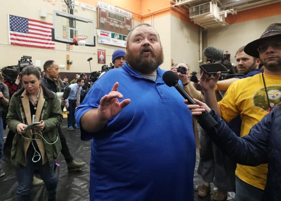 East Palestine Mayor Trent Conaway talks to a reporter before taking control of an informational meeting and turning it into an impromptu question and answer meeting at East Palestine High School on Wednesday.