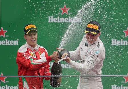 Formula One - F1 - Italian Grand Prix 2016 - Autodromo Nazionale Monza, Monza, Italy - 4/9/16 Mercedes' Nico Rosberg celebrates his win on the podium with Ferrari's Sebastian Vettel Reuters / Max Rossi Livepic