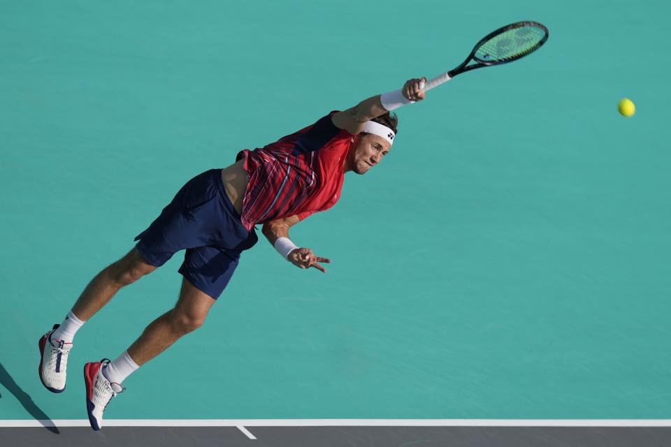 Casper Ruud of Norway serves to Carlos Alcaraz of Spain , during a match for the third place of the Mubadala World Tennis Championship, in Abu Dhabi, United Arab Emirates, Sunday, Dec. 18, 2022. (AP Photo/Kamran Jebreili)