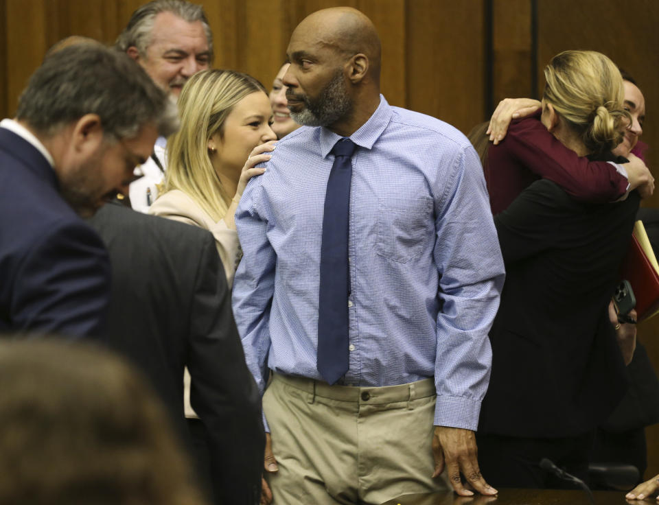 Lamar Johnson, center looks toward friends and family members as his attorneys celebrate on Tuesday, Feb. 14, 2023, after St. Louis Circuit Judge David Mason vacated his murder conviction during a hearing in St. Louis, Mo. Johnson served nearly 28 years of a life sentence for a killing that he has always said he didn't commit. (Christian Gooden/St. Louis Post-Dispatch via AP, Pool)