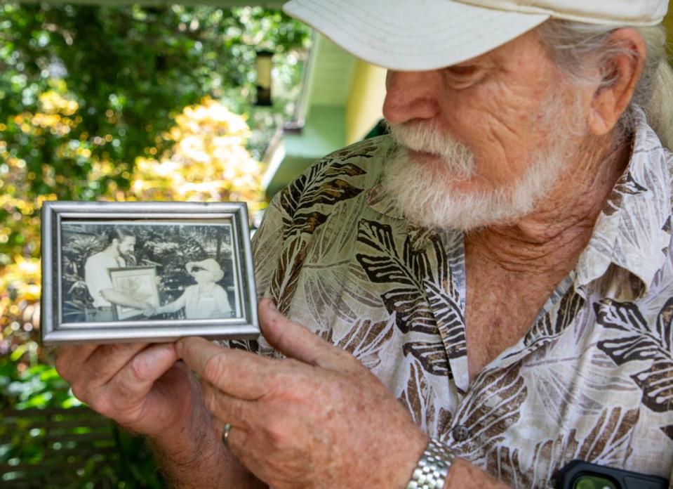 Roger Hammer shows a photo of when he received the first Marjory Stoneman Douglas Award presented by the Florida Native Plant Society in 1982, a few years after he discovered the atala butterfly believed to be extinct.
