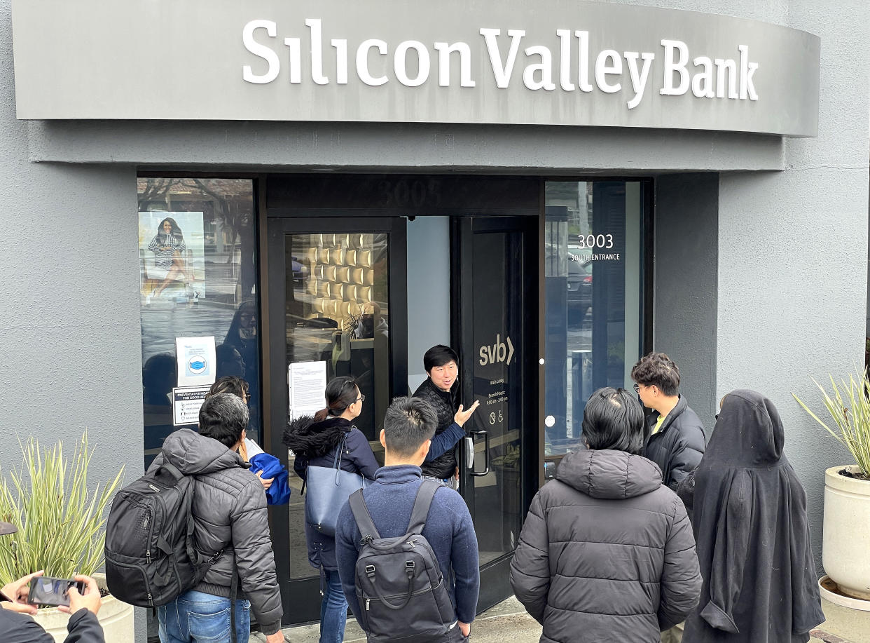 An SVB employee informs customers in Santa Clara, Calif., that the bank is closed