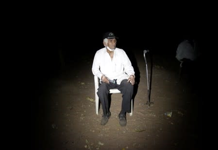 Ricardo Ruiz sits as he refuses to leave his home due to an evacuation in San Lorenzo Community, an area where wildfires have destroyed hectares of forest, near Robore