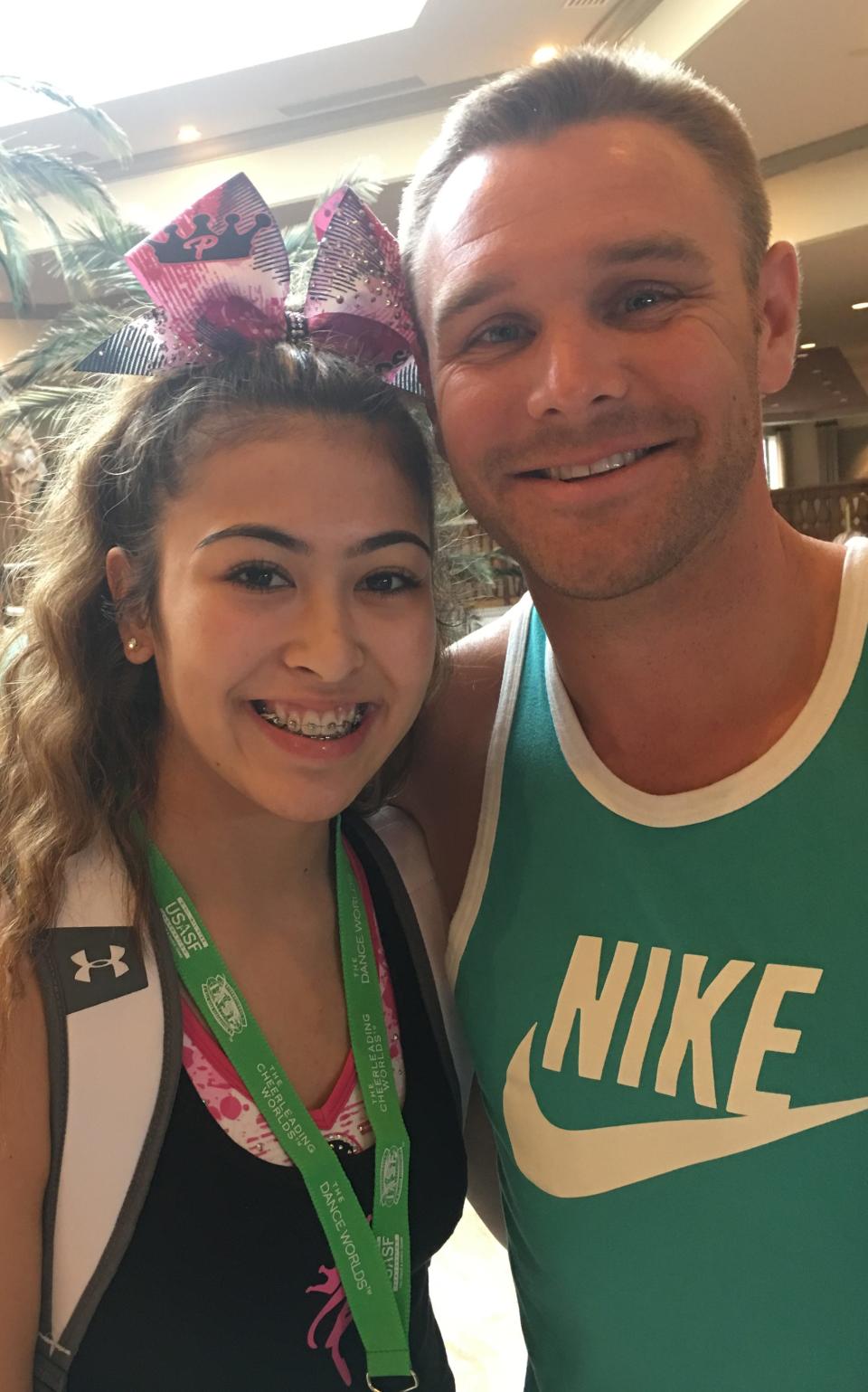 Caitlin Calip with her former cheer coach Mike Harmon