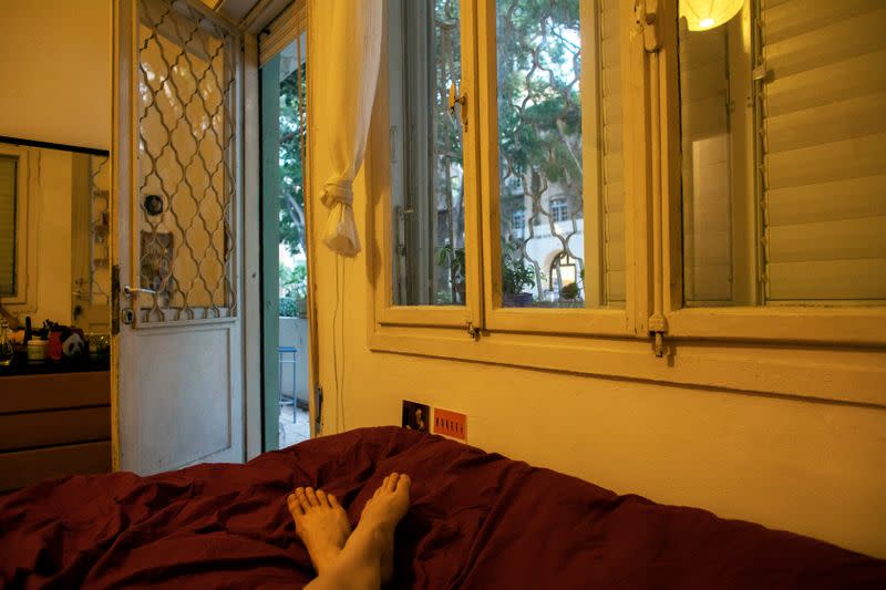 Yael Ben Ezer takes a photograph of the view she sees while lying on her bed after practicing in her apartment in Tel Aviv