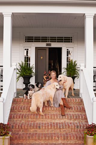 <p>Alison Gootee</p> At her home on Midway Farm, Caroline's ethos of "the more the merrier" extends to her many pets, including six dogs—the five shown with her are Clyde, Chloe, Dodge, Doc, and Penny.