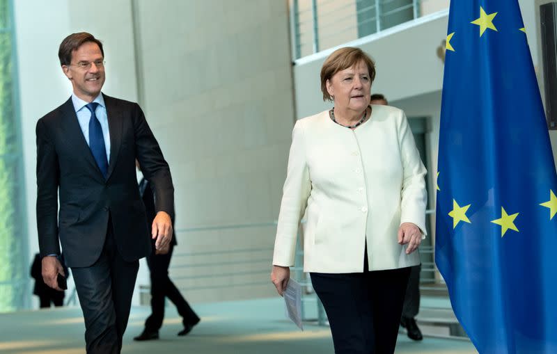 German Chancellor Angela Merkel and Dutch Prime Minister Mark Rutte arrive before speaking to reporters in Berlin