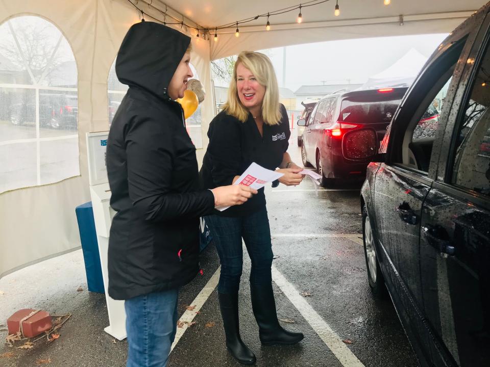 Shelly Sassen, executive director of The Well Outreach, greets volunteers during a Thanksgiving distribution drive-through on Sunday. Volunteer drivers delivered Thanksgiving essentials to almost 300 families across Spring Hill and Columbia.