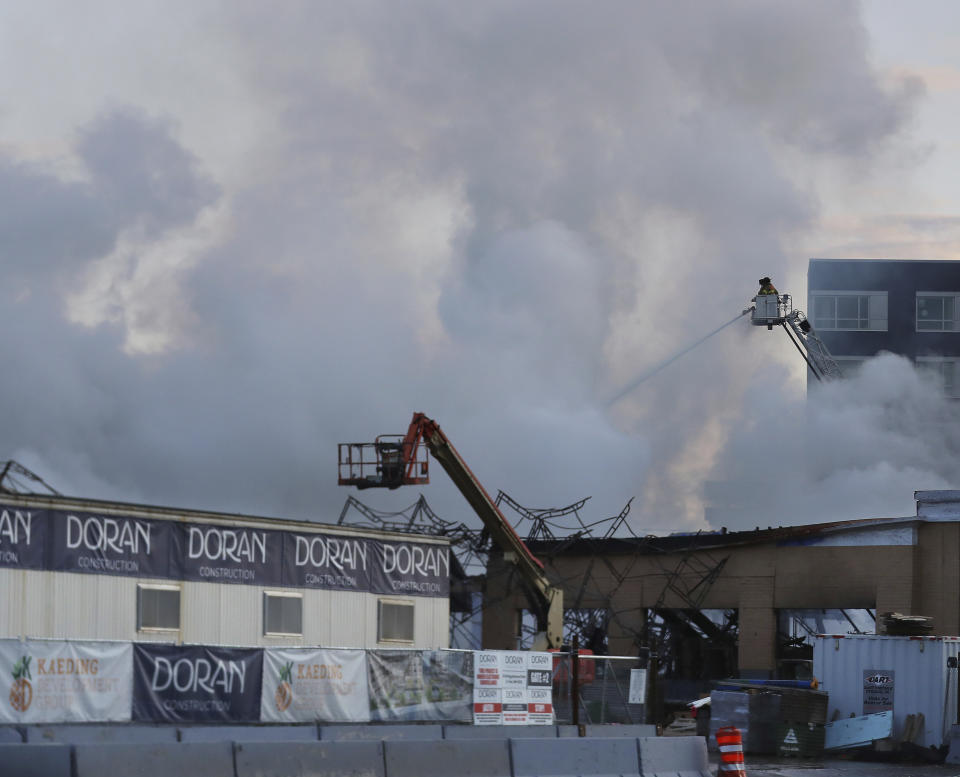 Firefighters battle a fire in downtown St. Paul, Minn., that has engulfed a building that was under construction on Tuesday, Aug. 4, 2020. There were no reports of injuries and there was no immediate word about the possible cause of the fire. (David Joles /Star Tribune via AP)