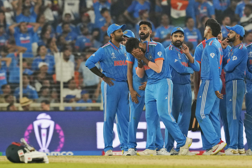India's Jasprit Bumrah, front, holds his head in disappointment after a not-out decision against Australia's Marnus Labuschagne was upheld by the third umpire during the ICC Men's Cricket World Cup final match between Australia and India in Ahmedabad, India, Sunday, Nov. 19, 2023. (AP Photo/Rafiq Maqbool)