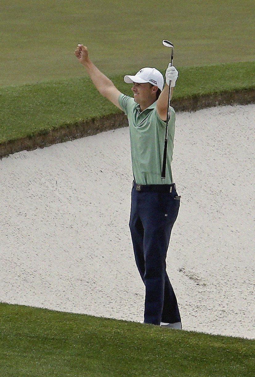 Jordan Spieth celebrates after chipping in for an birdie from a bunker on the fourth hole during the fourth round of the Masters golf tournament Sunday, April 13, 2014, in Augusta, Ga. (AP Photo/Charlie Riedel)