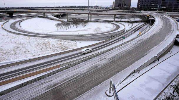 PHOTO: A lone driver makes their way through icy road conditions at the LBJ 635 Freeway and North Dallas Tollway interchange, Jan. 31, 2023, in Dallas. (Tony Gutierrez/AP, FILE)