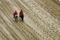 <p>Outriders walk on the track before the 144th running of the Kentucky Derby horse race at Churchill Downs Saturday, May 5, 2018, in Louisville, Ky. (Photo: Charlie Riedel/AP) </p>