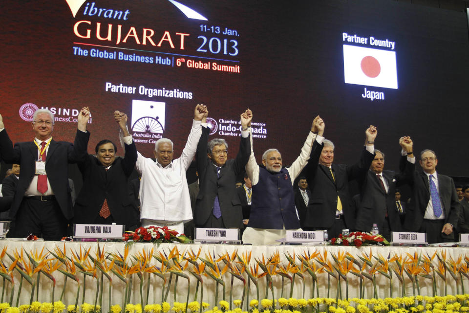 FILE - In this Jan. 11, 2013 file photo, Gujarat Chief Minister Narendra Modi, fourth right, poses with business leaders and other delegates during the inauguration of 6th Vibrant Gujarat Global Summit (VGGS) in Gandhinagar, India. To some, the man in pole position to be India’s next prime minister is a visionary reformer, while to others he’s an autocrat in bed with big business cronies. Perhaps nowhere are opinions of Narendra Modi more polarized than in Gujarat, the western state he’s led for more than decade and that is now touted as a model of prosperity for all of India to emulate.(AP Photo/Ajit Solanki, File)