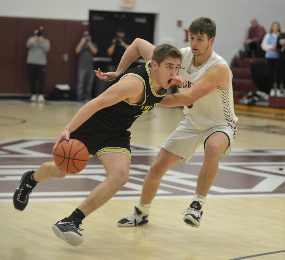 Tri-Valley's Erik Neal drives past John Glenn's Caleb Larrick during the Scotties' 50-48 MVL Big School Division win on Tuesday night.