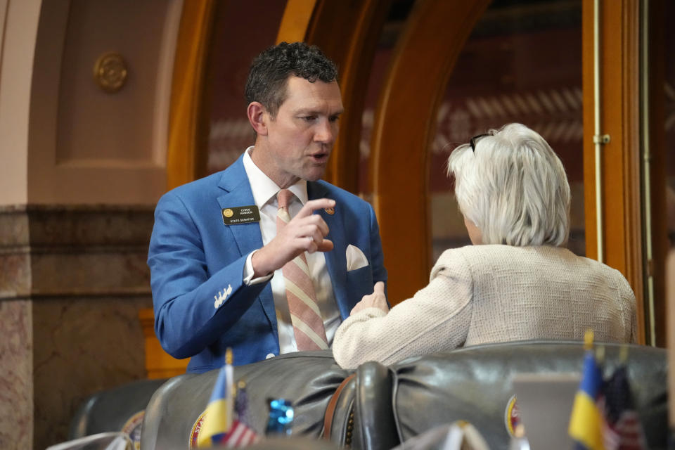 Colorado State Sen. Chris Hansen, D-Denver, left, confers with Sen. Joann Ginal, D-Fort Collins, in the body's chambers, Monday, May 8, 2023, in the State Capitol in Denver. (AP Photo/David Zalubowski)