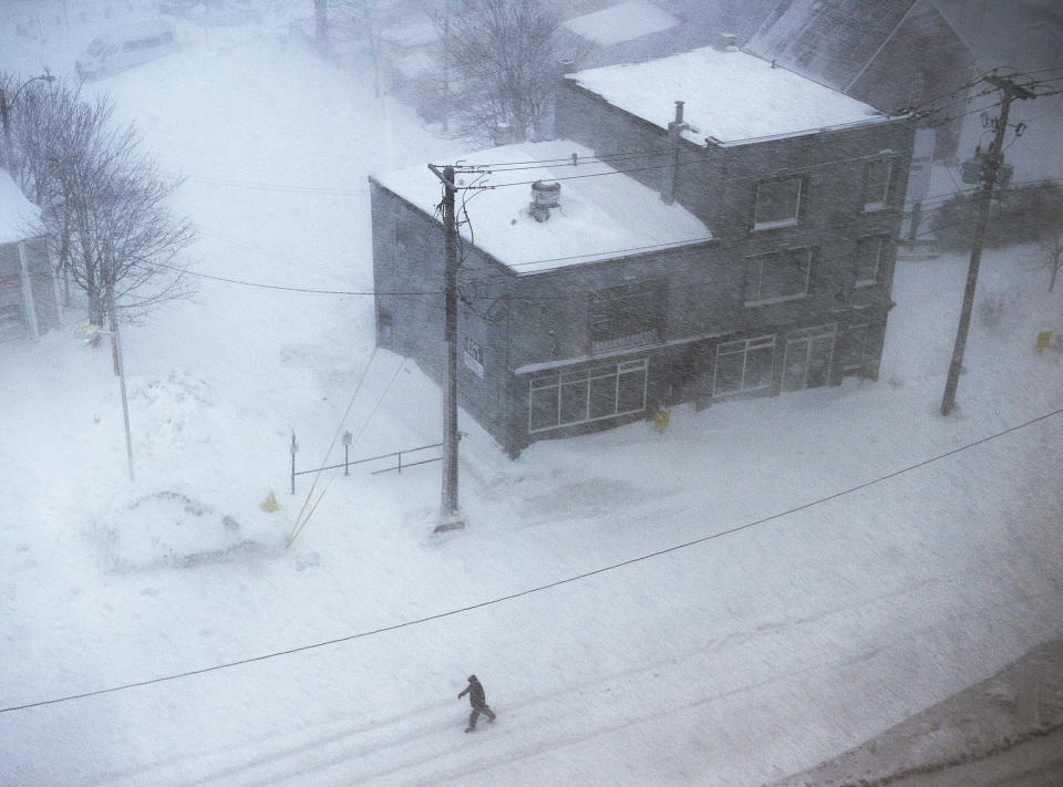 A man walks down the middle of New Gower St. as snow falls in St. John‚ Newfoundland on Friday, Jan. 17, 2020. The city has declared a state of emergency, ordering businesses closed and vehicles off the roads as blizzard conditions descend on the Newfoundland and Labrador capital. *Andrew Vaughan/The Canadian Press via AP)