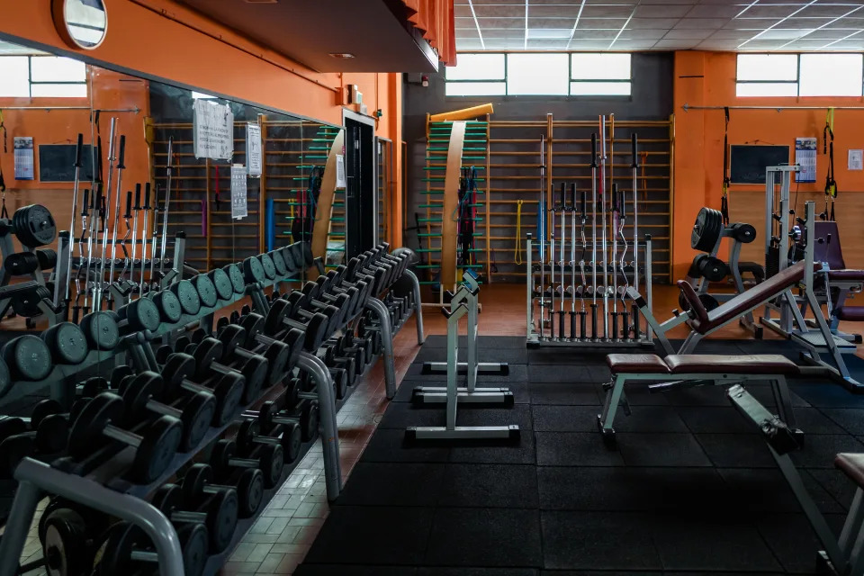 The weight room of the Olimpia Club gym is empty in the red zone in Molfetta on April 2, 2021. According to the results of the survey conducted by the sports search engine - which includes over 22,500 sports associations and sport-clubs in more than 1,500 Italian municipalities and a community of over 4 million users - during the Covid period, 66% of Italians did physical activity: of these, 34% practiced outdoor activities when possible, 19% alternated outdoor and home activities, another 18% practiced at home with video lessons, 17% in home alone, 7% at home both alone and with video lessons. Important data that, underlined by Orangogo, tell how the need for movement and psycho-physical well-being related to sporting activity emerges, whatever it may be. And another fact emerges: Italians like online lessons, but they are not entirely satisfying. Meanwhile, the gyms and swimming pools have been closed for 4 months now. Four very long months, an eternity for those who have to pay rents, salaries, bills. At the end of October, stopping gyms, fitness centers and swimming pools after the increase in infections in Italy seemed the right solution to stem the second wave. A temporary stop, which no one imagined so long with the risk that they will never reopen. (Photo by Davide Pischettola/NurPhoto via Getty Images)