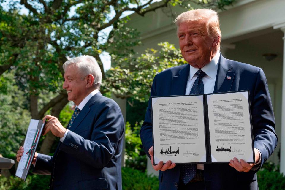 US President Donald Trump and Mexican President Andres Manuel Lopez Obrador hold up a joint declaration during a joint press conference in the Rose Garden of the White House on July 8, 2020, in Washington, DC.