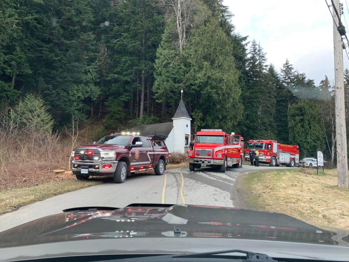 Emergency vehicles are seen outside the Usk Pioneer Chapel in Usk, B.C., on Friday. Officials say a fire at the historic building located on Highway 16 northeast of Terrace is being treated as suspicious. (Usk Pioneer Chapel/Facebook - image credit)