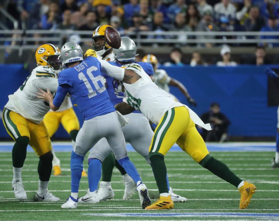 Detroit Lions quarterback Jared Goff fumbles after the hit by Green Bay Packers linebacker Preston Smith during the first half at Ford Field, Thursday, Nov. 23, 2023.