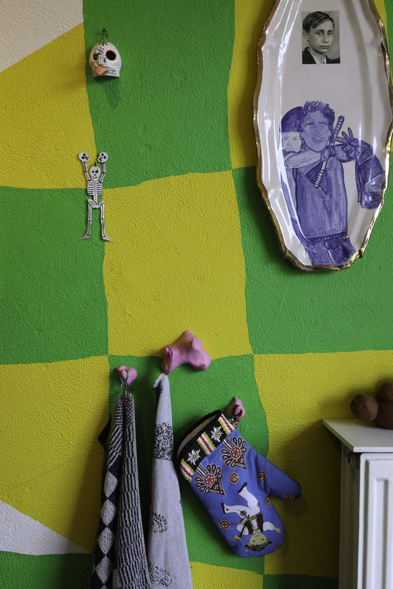 detail of green and yellow checked painted kitchen wall