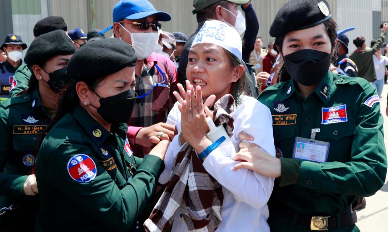 <span>The Cambodian environmental activist Phuon Keoraksmey (centre) is arrested near the Phnom Penh municipal court after the verdict.</span><span>Photograph: Kith Serey/EPA</span>