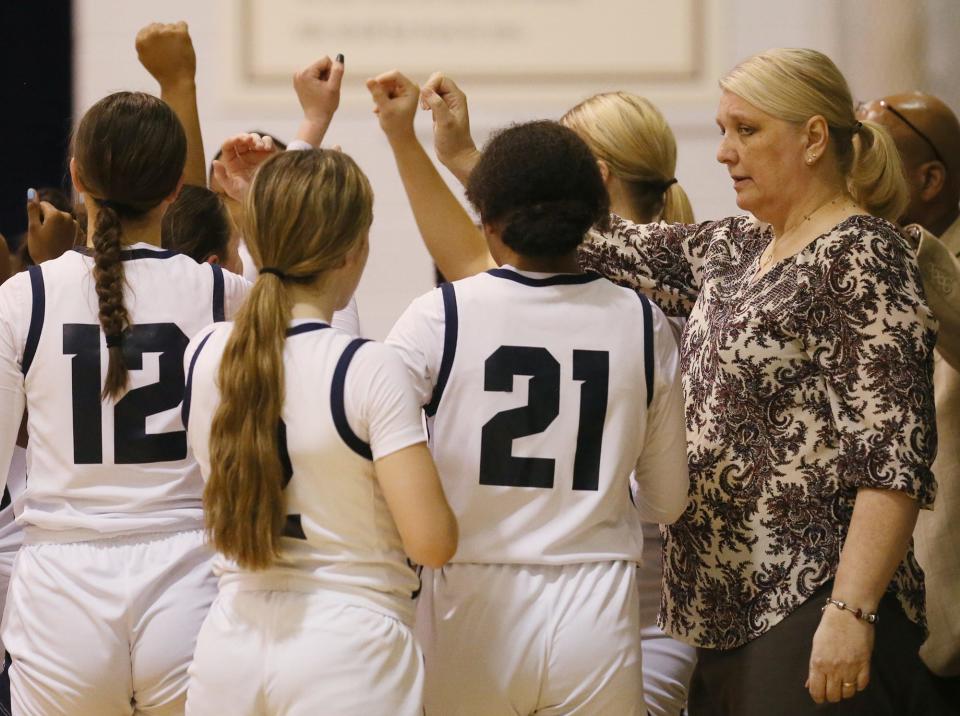 Archbishop Hoban coach Pam Davis joins her players before the start of a game against Walsh Jesuit on Dec. 14, 2022, in Akron.