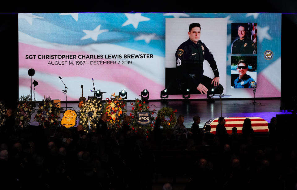 Mourners enter the church sanctuary for the funeral of Houston Police Sgt. Christopher Brewster, Thursday, Dec. 12, 2019, at Grace Church Houston in Houston. Brewster, 32, was gunned down Saturday evening, Dec. 7, while responding to a domestic violence call in Magnolia Park. Police arrested 25-year-old Arturo Solis that night in the shooting death. Solis faces capital murder charges. (Melissa Phillip/Houston Chronicle via AP, Pool)