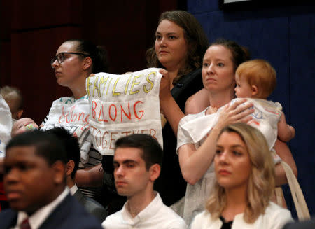 Protesters with children demonstrate against the Trump administration's practice of separating children from their parents at the U.S.-Mexico border before U.S. Department of Justice Inspector General Michael Horowitz testified to a joint hearing of the House Judiciary and House Oversight and Government Reform Committee titled, "Oversight of the FBI and DOJ Actions in Advance of the 2016 Election" on Capitol Hill in Washington, U.S., June 19, 2018. REUTERS/Joshua Roberts