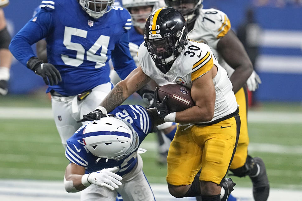 Pittsburgh Steelers running back Jaylen Warren (30) gets past Indianapolis Colts safety Julian Blackmon (32) during the first half of an NFL football game in Indianapolis Saturday, Dec. 16, 2023. (AP Photo/Darron Cummings)