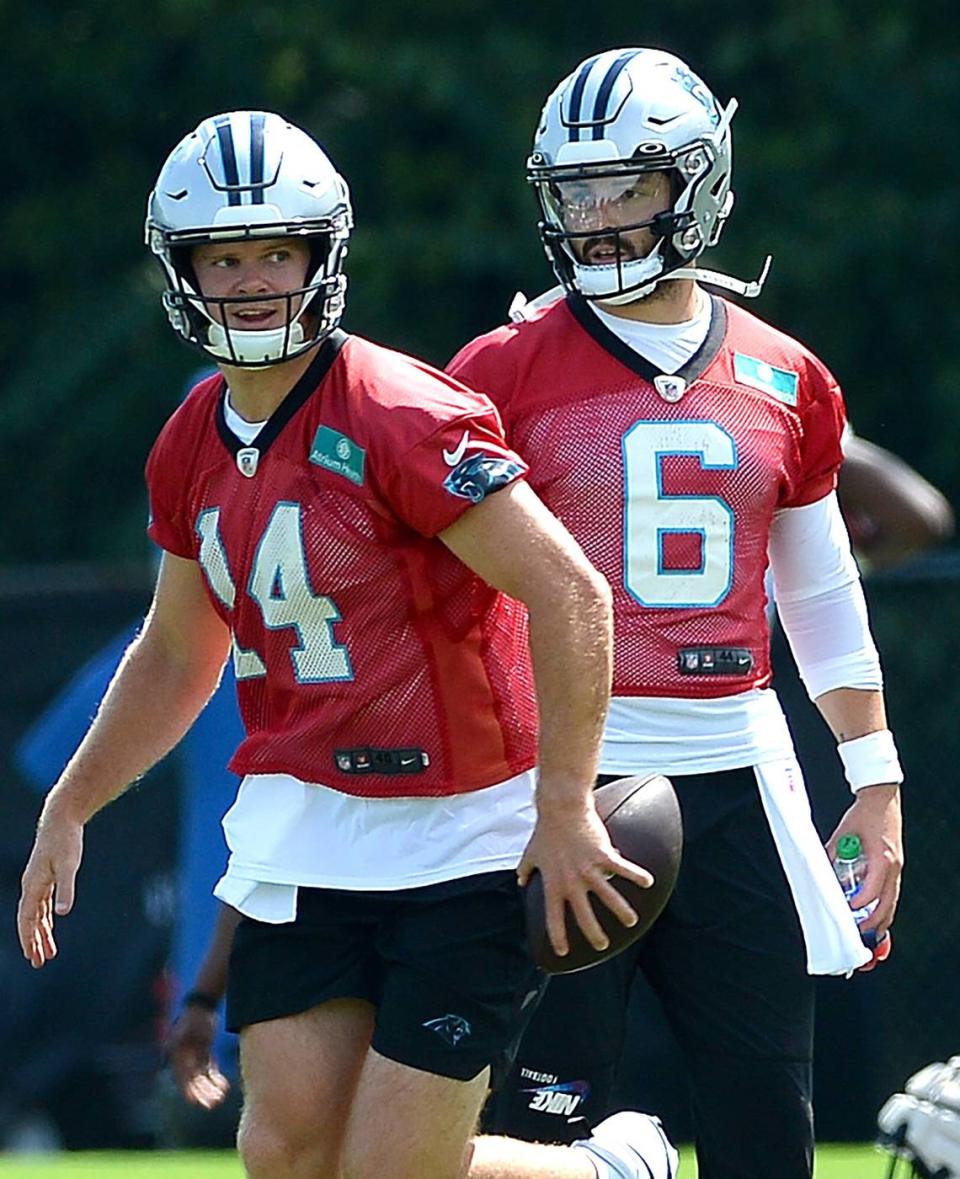 Carolina Panthers quarterback Sam Darnold, left, jogs off to begin drills as quarterback Baker Mayfield, right, looks on. The Panthers held their first training camp practice on Wednesday, July 27, 2022 at Wofford College in Spartanburg, SC.