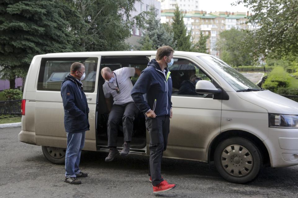 German medics arrive at the Omsk Ambulance Hospital No. 1, intensive care unit where Alexei Navalny was hospitalized in Omsk, Russia, Friday, Aug. 21, 2020. Russian doctors treating opposition leader Alexei Navalny say they don't believe he was poisoned and refused to transfer him to a German hospital. (AP Photo/Evgeniy Sofiychuk)