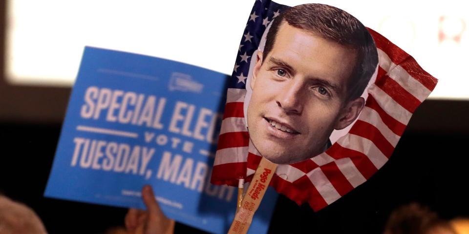 Supporters of Conor Lamb, the Democratic candidate for the March 13 special election in Pennsylvania's 18th Congressional District hold signs during his election night party in Canonsburg, Pa., Wednesday, March 14, 2018.