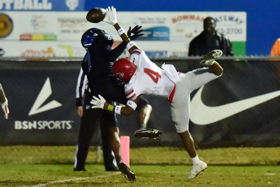 Trinity Christian's Fred Highsmith (7) has a pass broken up by Quincy Munroe's Ostin Perkins (4) during the second quarter Friday, Nov. 26, 2021 at Trinity Christian Academy in Jacksonville. Trinity Christian and Quincy Munroe faced off during an FHSAA 2A Region 1 Championship. Trinity defeated Munroe 39-22 and advance to the final four. 