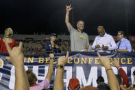 Louisiana-Lafayette head coach Billy Napier, center, soon to be Florida head coach, salutes fans after the team defeated Appalachian State in the Sun Belt Conference championship NCAA college football game in Lafayette, La., Saturday, Dec. 4, 2021. (AP Photo/Matthew Hinton)