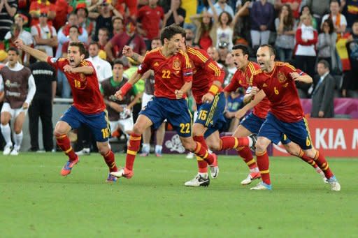 Spanish players celebrate at the end of the penalty shoot out of the Euro 2012 football championships semi-final match Portugal vs. Spain at the Donbass Arena in Donetsk. Spain reached their third consecutive major tournament final after overcoming neighbours Portugal 4-2 on penalties