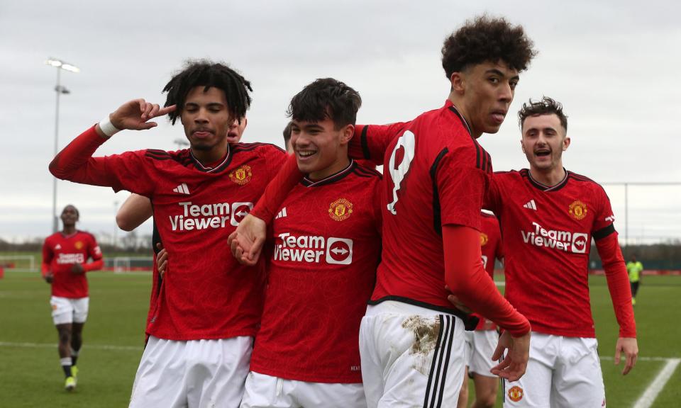 <span>Ethan Williams (left) of Manchester United’s Under-18s celebrates scoring their third goal in a 4-2 cup win against Arsenal on Saturday. </span><span>Photograph: John Peters/Manchester United/Getty Images</span>