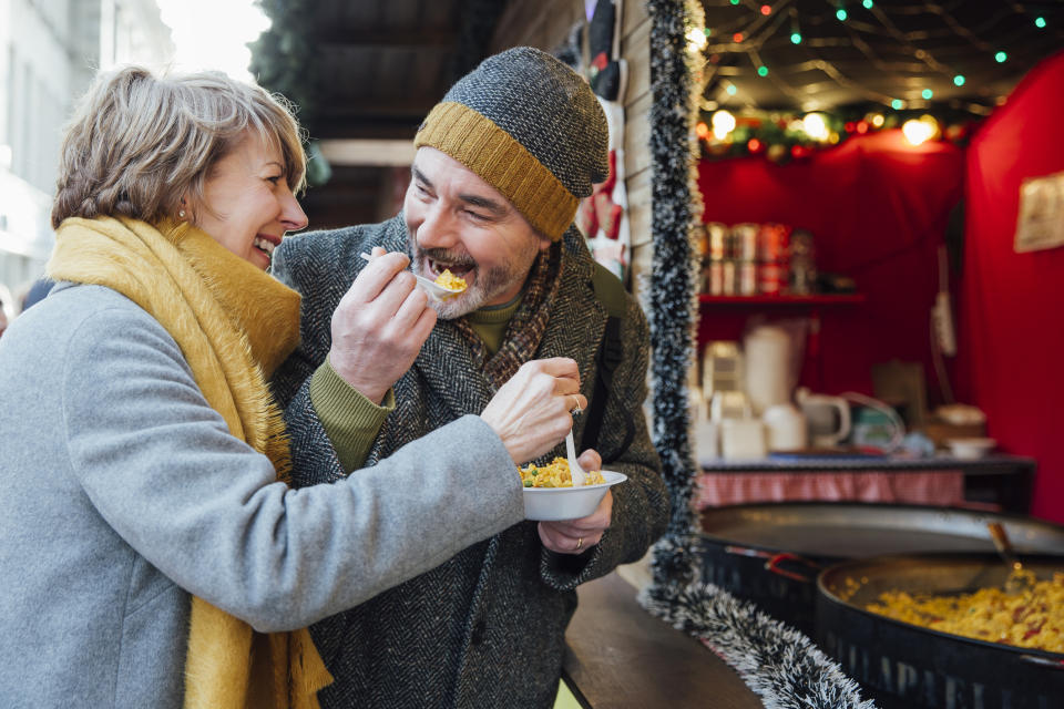 Senior couple sharing a bowl of rice outdoors