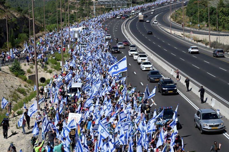 Tens of thousands of Israeli protesters wave the national flag during a march to Jerusalem against Prime Minister Benjamin Netanyahu's government plans to overhaul the judicial system, on a highway near Abu Gosh, on Saturday, July 22, 2023. The protesters will set up camp near the Israeli Knesset, Parliament, in a last ditch effort to stop the judicial overhaul bill. Photo by Debbie Hill/ UPI