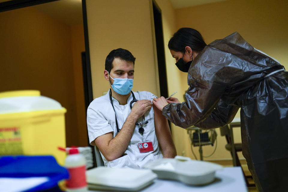 A nurse administrates a Pfizer/Biontech COVID-19 vaccine to a health care worker during the national launch of the vaccination of hospital staff at the CHR Citadelle hospital in Liege​, Belgium, Monday, Jan. 18, 2021. Indications that the new variant of COVID-19 first detected in Britain is now starting to gain a foothold in Belgium are increasing Monday with cases reported several schools in the north of the country on top of an outbreak in a care home. (AP Photo/Francisco Seco)