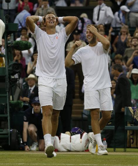 Vasek Pospisil of Canada, left, and Jack Sock of the U.S celebrate defeating Bob Bryan and Mike Bryan of the U.S in the men's doubles final at Wimbledon. (AP Photo/Sang Tan)