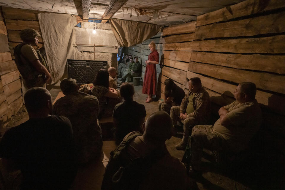 Medic volunteer Nataliia Voronkova, top right, gives a medical tactical training session to soldiers in a bomb shelter as air raid sirens go off, in Dobropillia, eastern Ukraine, Friday, July 22, 2022. Voronkova has dedicated her life to aid distribution and tactical medical training for soldiers and paramedics, working on front line of the Donetsk region since the war began in 2014. (AP Photo/Nariman El-Mofty)